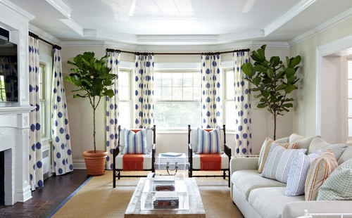 Sunny living room with kitchen in the back and expansive windows showing the backyard